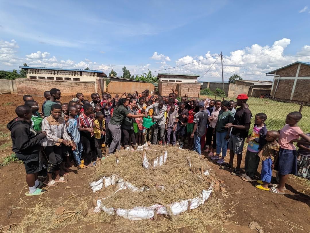 EP Mulinja students building a kitchen garden with Roots & Shoots Rwanda