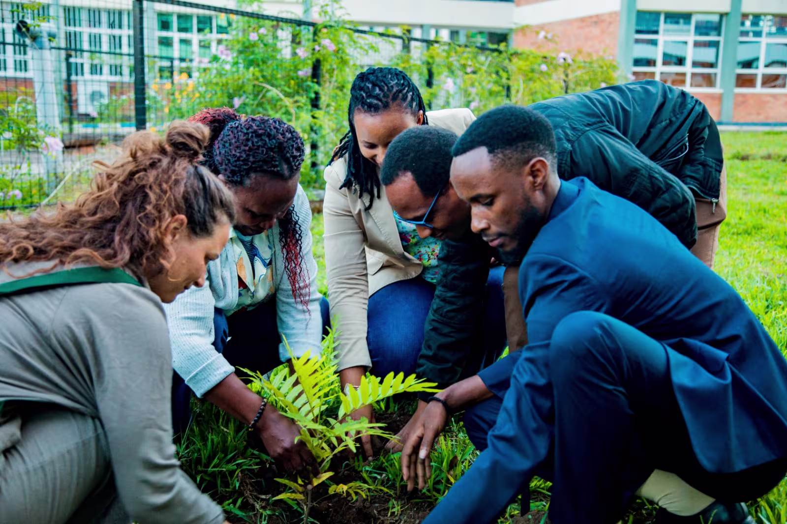 Members of the INES-Ruhengeri Environmental Club participating in a tree planting activity with Roots & Shoots Rwanda