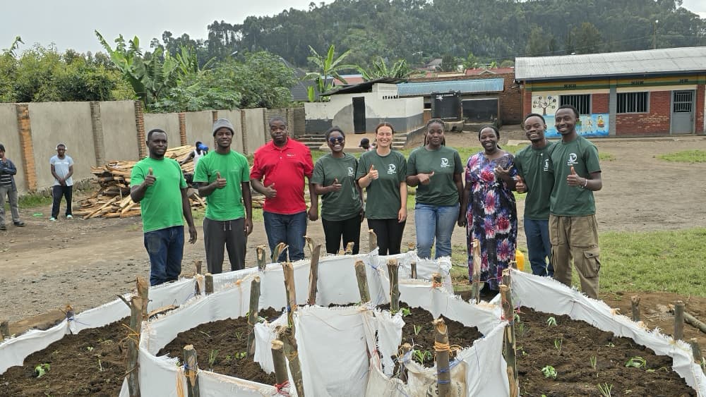 Students participating in a kitchen garden activity with Roots & Shoots Rwanda